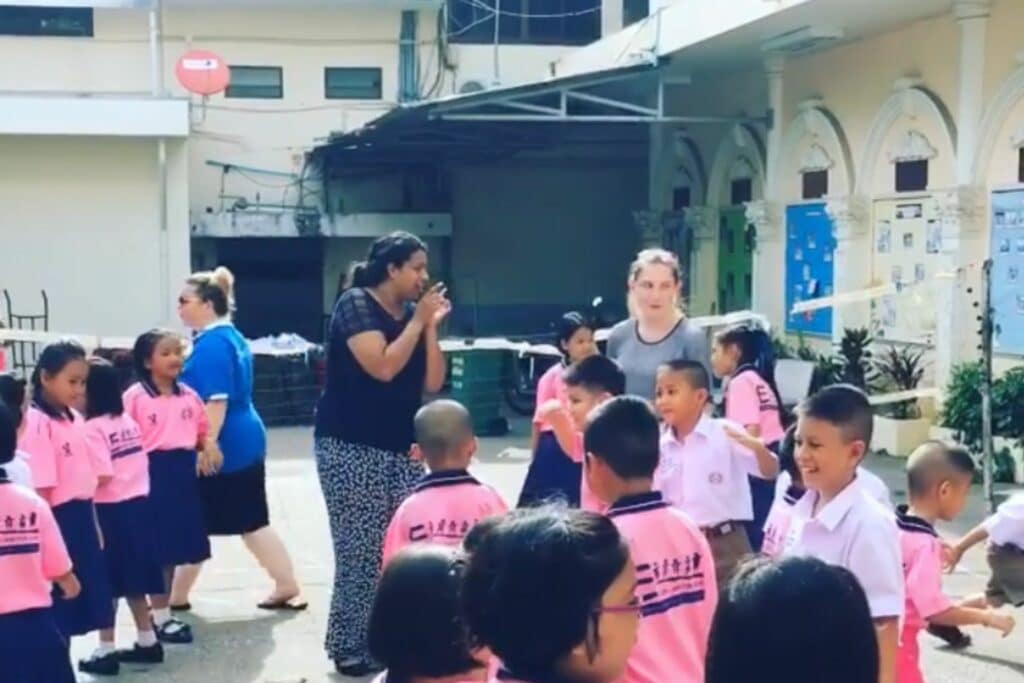 2 foreign teachers with Thai students doing activities